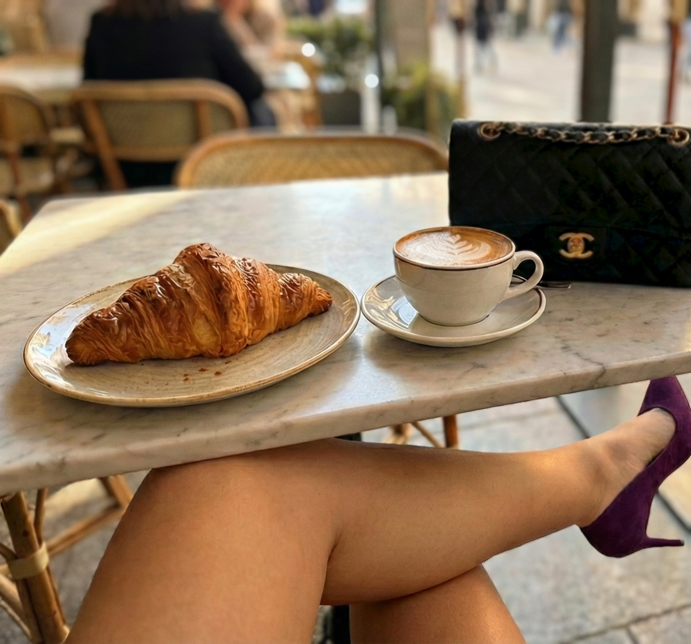 Spoilt findom Goddess Lacia Lucis at a cafe relaxing while receiving tributes and session bookings