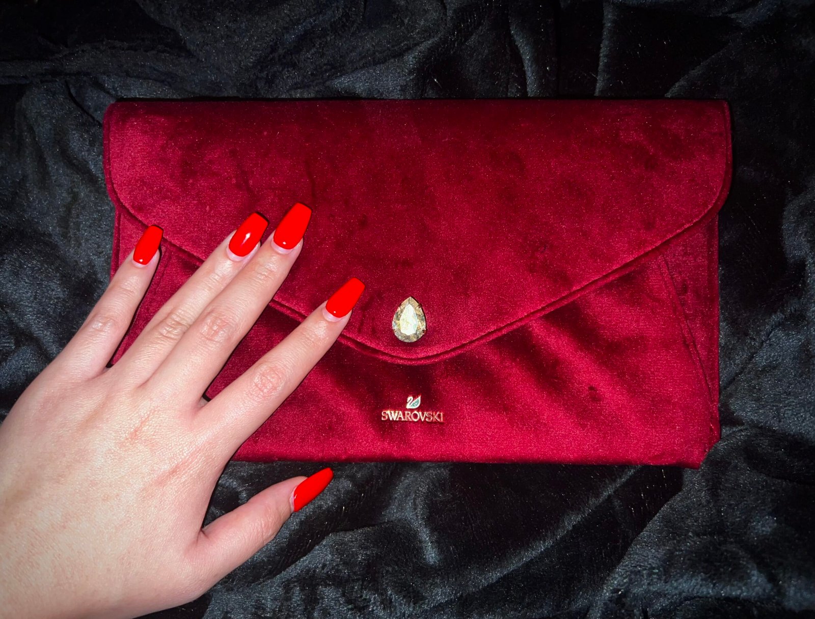 Red nails and Swarovski velvet envelope to be filled with tributes from finsubs